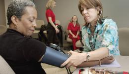 Doctor taking patients' blood pressure measurement