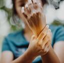 Young person holding their wrist